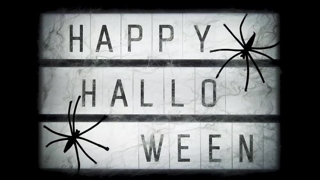 Turn on and turn off lightbox with text Happy halloween decorated cobwebs and spiders, closeup. Halloween concept.