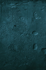 Urban concrete wall background with grooves and bubbles. Cement gray wall. Urban and industrialization art concept. Texture like concrete, stone, cement, plaster.. Poster mockup. Сloseup studio shot.