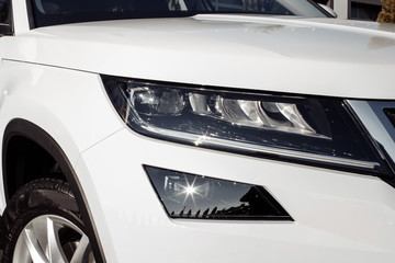 modern and elegant white car - Closeup of car headlight with copy space. white car headlight.