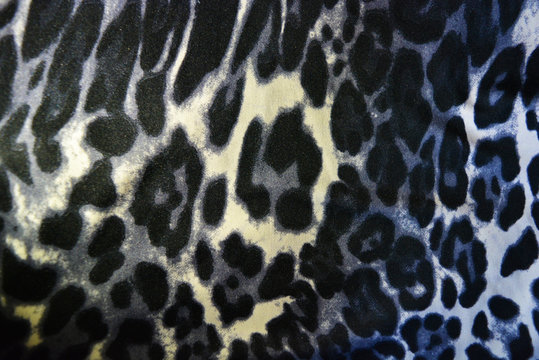 Beautiful animal print with spots, leopard pattern and animal skin, white-brown with gray spots.