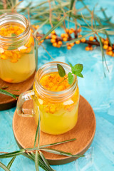 Colorful hot sea buckthorn tea with ginger and honey