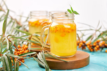 Colorful hot sea buckthorn tea with ginger and honey