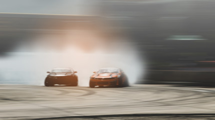 Abstract blurred two drift cars battle with smoke from burned tire © applezoomzoom