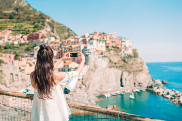 Fototapeta na wymiar Tourist looking at scenic view of Manarola, Cinque Terre, Liguria, Italy