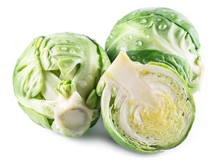 Fototapeta premium Green brussel sprouts with water drops on them on white background.