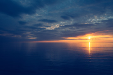 Aerial breathtaking sunset, view from a drone, sun going down in the horizon, amazing light