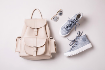 Fototapeta White backpack and pastel blue sneakers - fashion accessories obraz