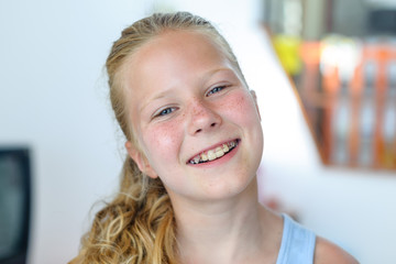 A teenage girl with a removable orthodontic appliance. Smiling with a bracket on her teeth. The...