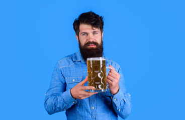 Celebration oktoberfest festival. Beer time. Bearded man holds beer glass. Handsome man drinks ale at bar or pub. Beard man drinking beer from mug. Young man tasting draft beer. Lager and dark ale.