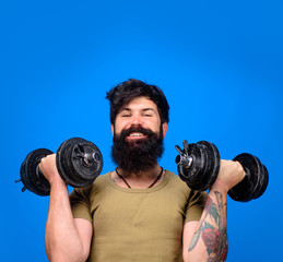Fototapeta na wymiar Sportsman making weightlifting. Young man exercise with dumbbells. Fit handsome athlete man holds dumbbells for weight training at gym. Fitness. Strong man training with dumbbells. Muscular sportsman.