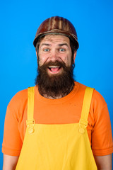 Mechanical worker. Industrial worker. Happy bearded man in overalls and construction helmet. Construction worker in hardhat. Business, building, industry, technology. Builder in hard hat. Man builder.