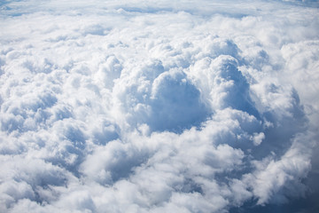 top view from airplane window of blue sky with cloudy background.