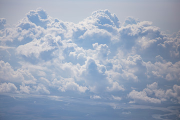 top view from airplane window of blue sky with cloudy background.