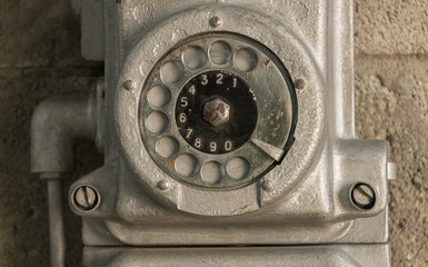 Antique phone with disk mechanical close up. Metalic