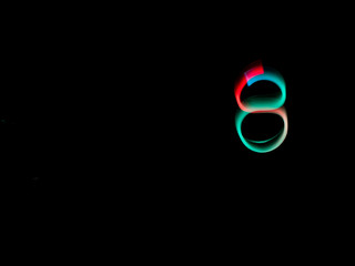 Numbers, from 0 to 9, made with colour lanterns and black background, using the technique of light painting.