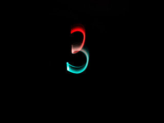 Numbers, from 0 to 9, made with colour lanterns and black background, using the technique of light painting.