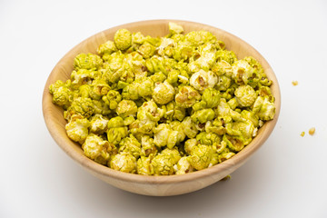 Japanese matcha green tea popcorn in the wooden bowl bulk isolated on white back ground