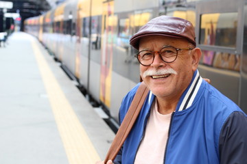 Senior Hispanic man at train station