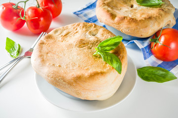 Two portion homemade Chicago Pizza Pot Pie with cheese, minced beef meat and vegetables, with pots and ingredients on domestic table copy space
