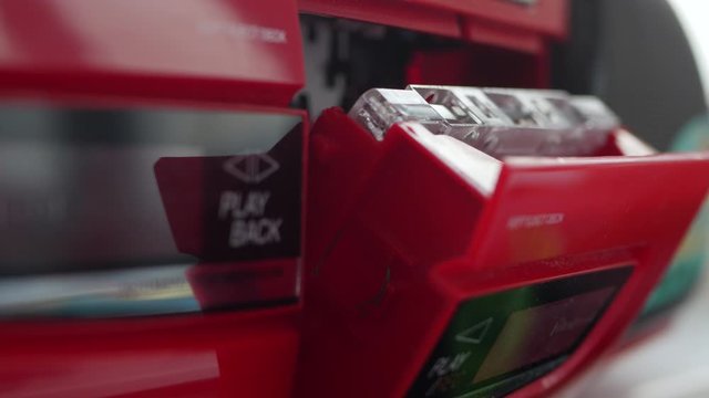 Man Pushing The Eject Button And Open Audio Cassette Door.