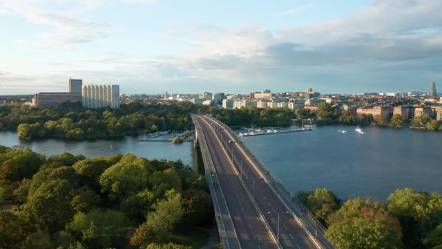 Aerial view Vasterbron Stockholm Sweden, drone flies backward over city park and traffic