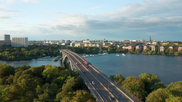 Drone flies across bridge and traffic, aerial view Vasterbron Stockholm Sweden