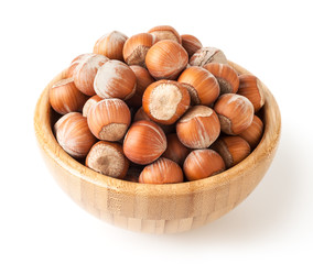 Hazelnuts in wooden bowl isolated on white background with clipping path