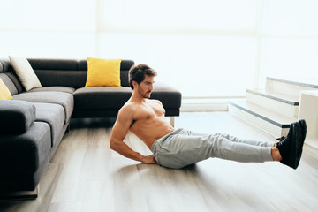 Young Man Working Out At Home For Healthy Lifestyle And Fitness