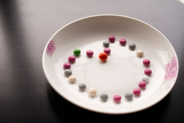 Obraz na płótnie Canvas Chocolate ball candy Heart shape on a plate for Valentine's day