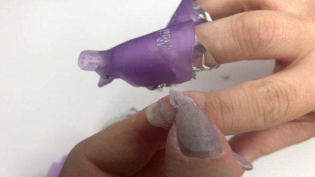 Soak-off UV gel polish removal. Womens nails wrapped in cotton pads soaked in acetone and aluminium foil. Manicure process, removing cracked gel nail polish from natural nails.