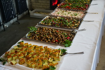 Catering food displayed on a buffet table: omelette with vegetables, mushrooms, grilled aubergines,...