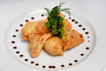 Plate of chicken nuggets on gray background