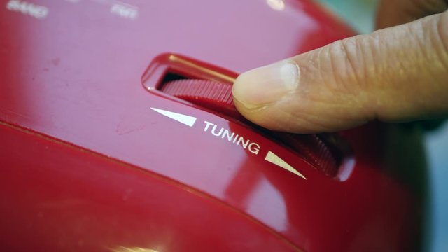Man's Finger Tuning A Radio On A Red Old Retro Vintage Ghettoblaster.