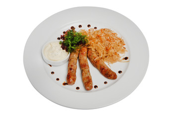 Raw pork sausages closeup view. Hunting grilled sausages and stewed cabbage on a plate isolated on white background