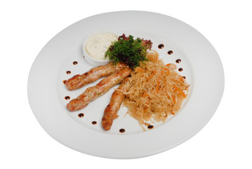 Raw pork sausages closeup view. Hunting grilled sausages and stewed cabbage on a plate isolated on white background