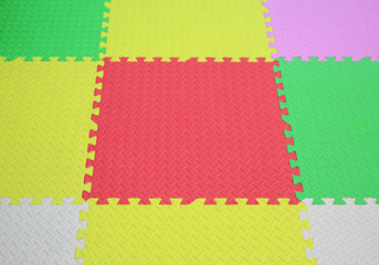 Colorful foam baby playground mat for kid. Soft mat rubber jigsaw background.