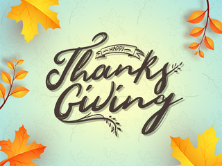 Calligraphy of Happy Thanksgiving with autumn leaves decorated background can be used as greeting card or poster design.