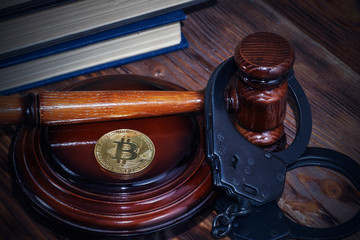 bitcoin, judge's hammer, handcuffs. Concept bitcoin ban, violation of the law.