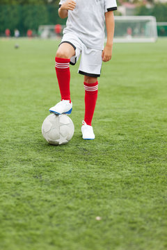 Cute  child dreams of becoming a soccer player. Boy plays football