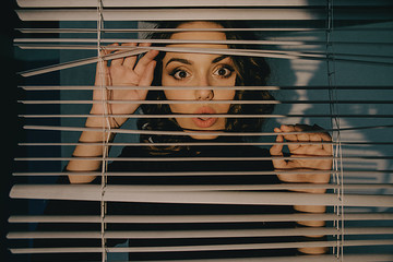 Portrait of young woman sun blinds window shutter artistic version  - obrazy, fototapety, plakaty