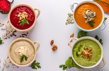 Variety of colorful vegetables cream soup: with broccoli, beets, white beans and pumpkins, healthy eating concept, Copy space, Horizontal orientation