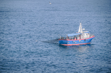 Small fishing boat collecting net