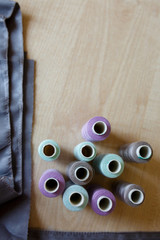 Still life. Sewing supplies. Thread and fabric on a wooden table