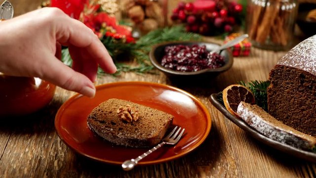 Gingerbread cake. Decorating a portion of cake with nut. Christmas decoration.