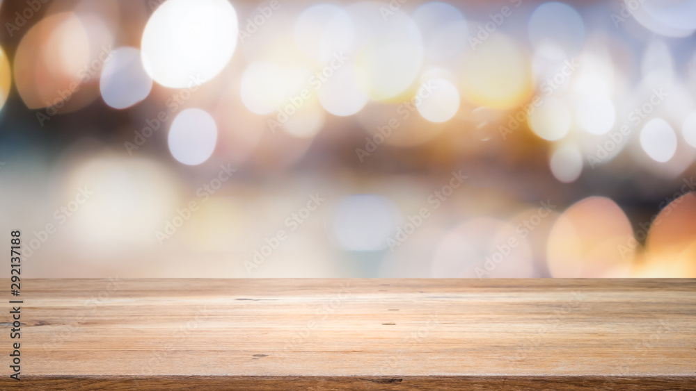 Wall mural wood table top on bokeh abstract background and used for montage or display products.