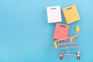 Abstract design element, concept of annual sale, shopping season - mini yellow cart with paper bag...
