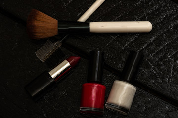 Various cosmetics on a black background. Beauty products, close up photo.
