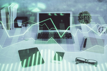 Stock market graph and table with computer background. Double exposure. Concept of financial analysis.