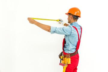 Worker in hard hat measure with ruler. Isolated on a white background.
