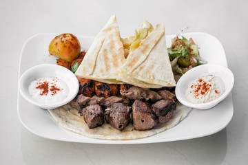 lebanese meshwi mixed grilled meat set on plate